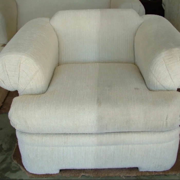 a white couch with a dirty cushion