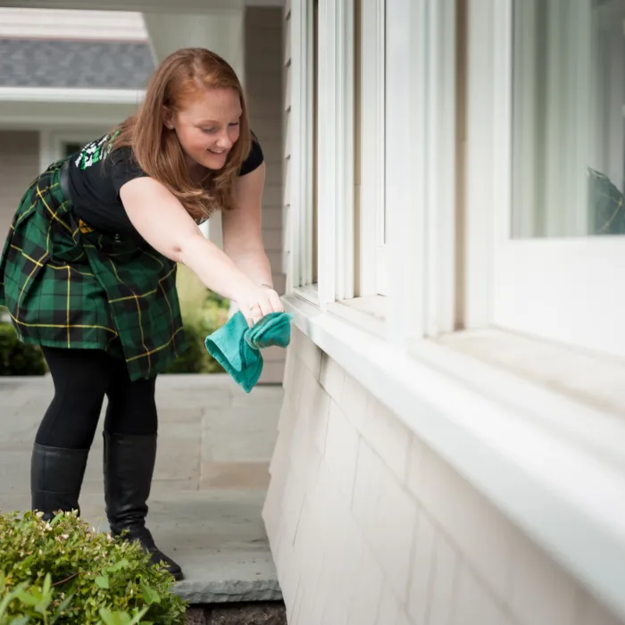 a woman cleaning a window