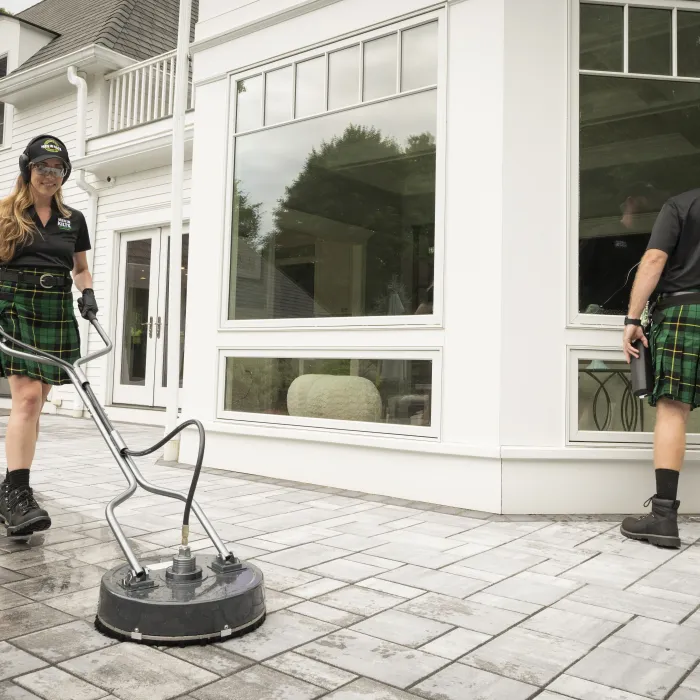 a woman in a kilt standing next to a man in a kilt and a kilt