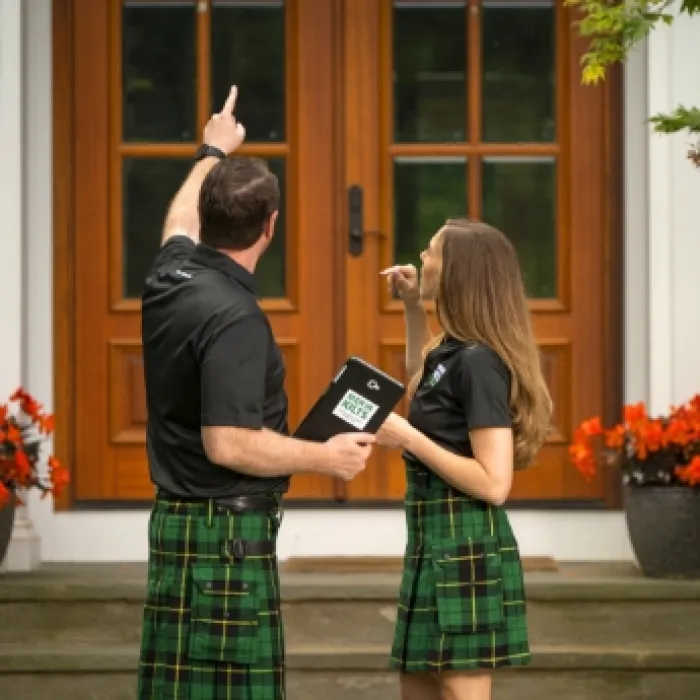 a man and a woman standing on stairs with their hands up