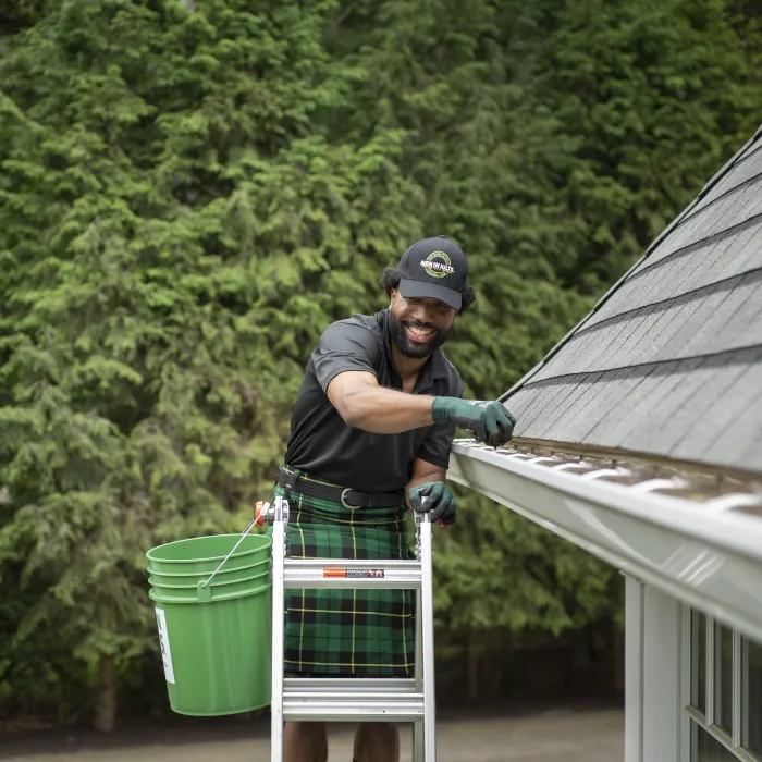 a person holding a green bucket