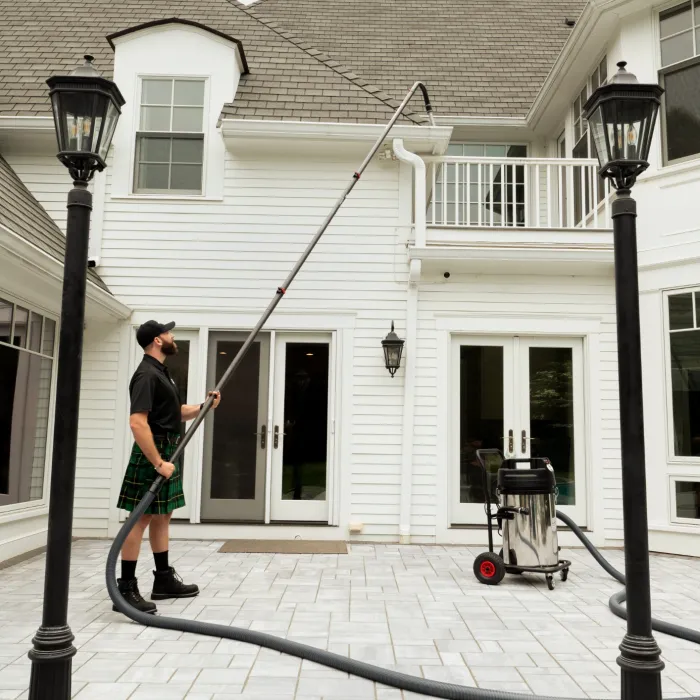 a man cleaning a gutter