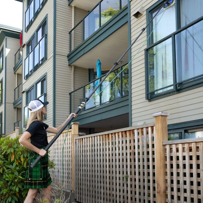 a man holding a broom outside a building