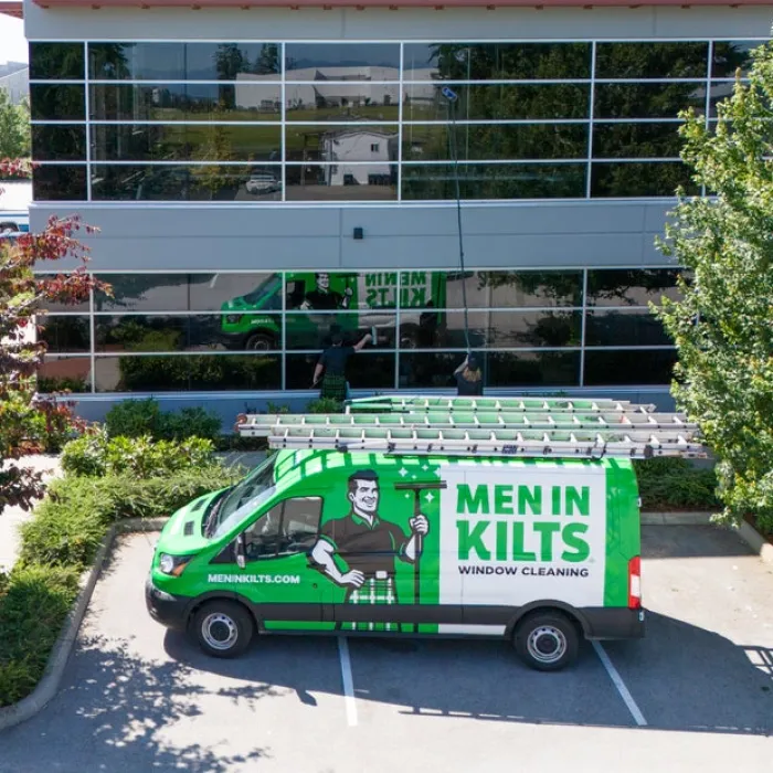 a green truck parked outside a building