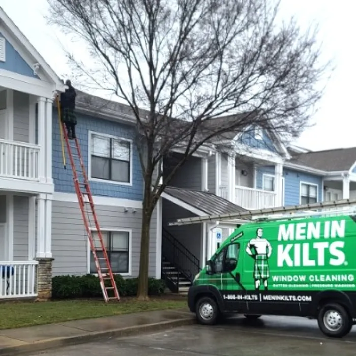 a green truck parked in front of a house