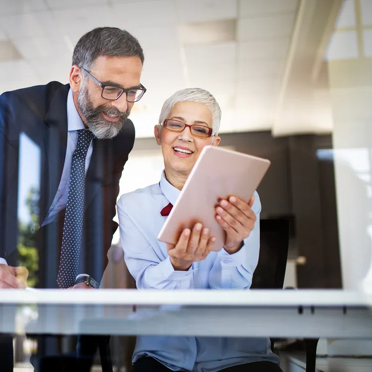 a man and a woman looking at a paper