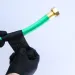 a close-up of hands holding a green tube