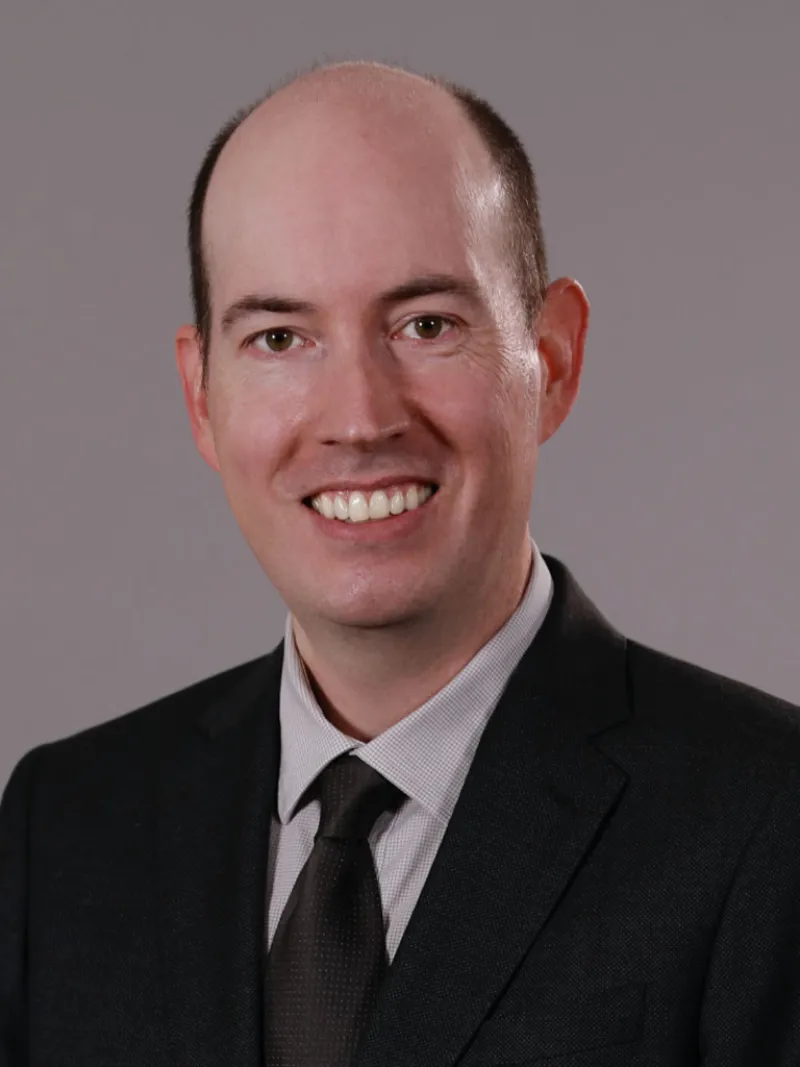lawyer Timothy J Hennessy in a suit smiling