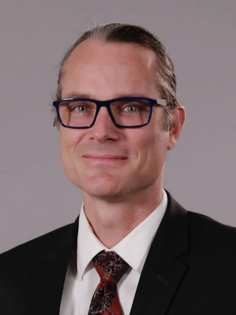 lawyer Curtis Vandermolen wearing glasses and a suit
