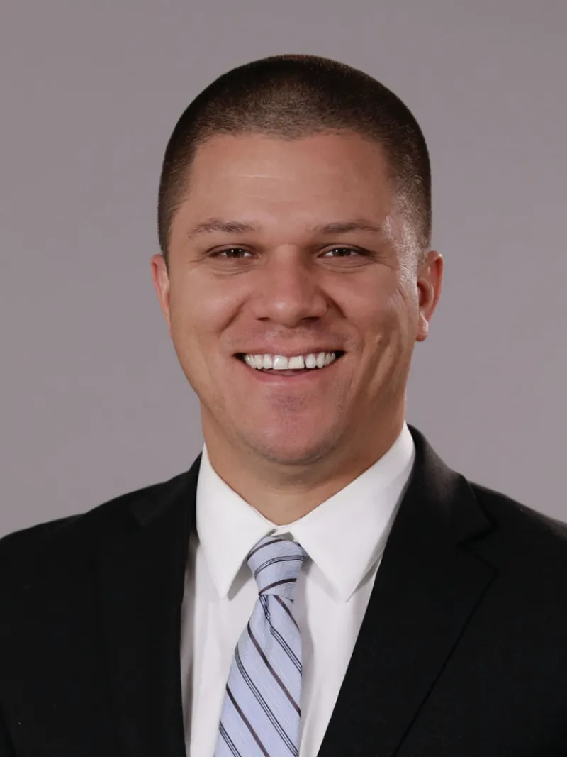 lawyer Gregory M Narvaez in a suit smiling