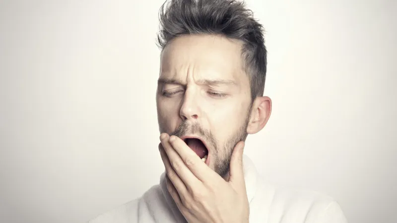 a man with his hand on his face