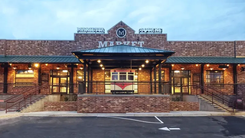 a building with a brick wall and a brick walkway