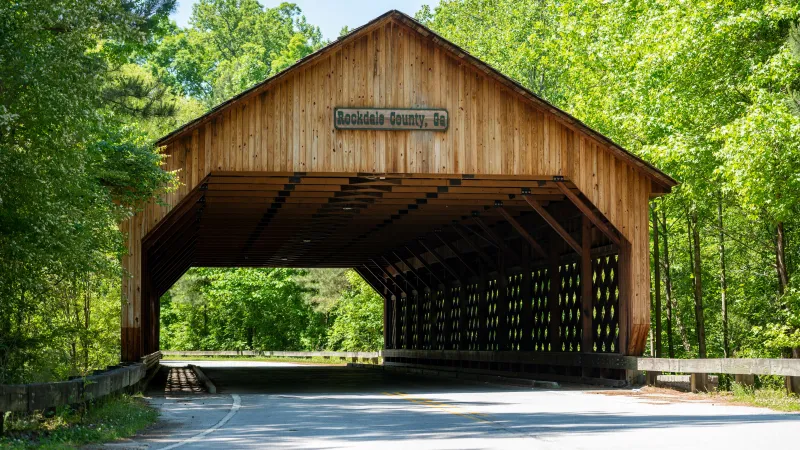 a wood building with a sign on it