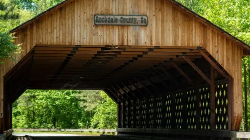 a wooden building with a sign