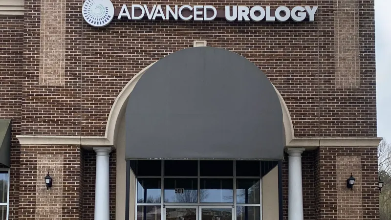 a brick building with a sign above the door