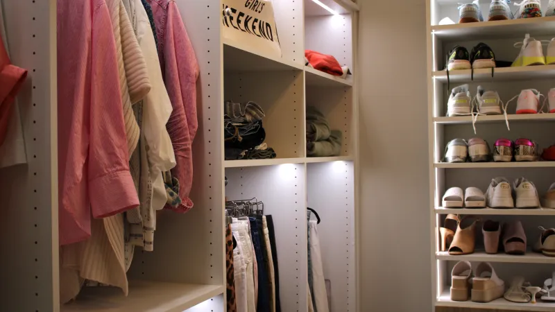 a closet with clothes and shoes