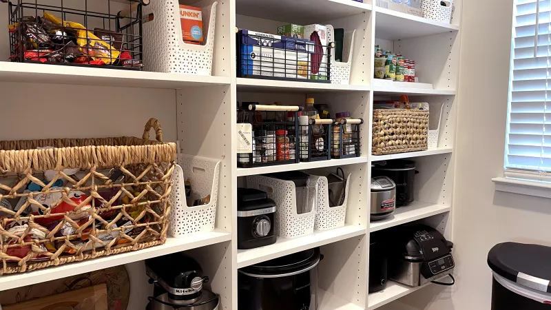 a white shelving unit with various items on it