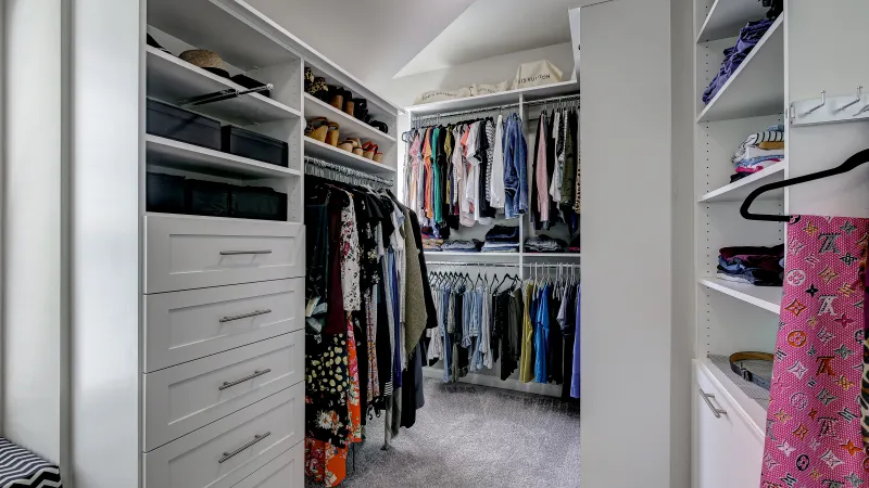 a closet with clothes and closets