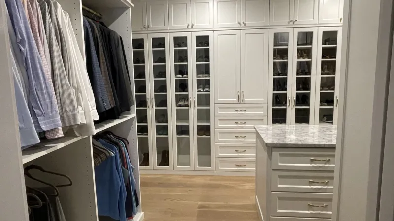 a white closet with white cabinets