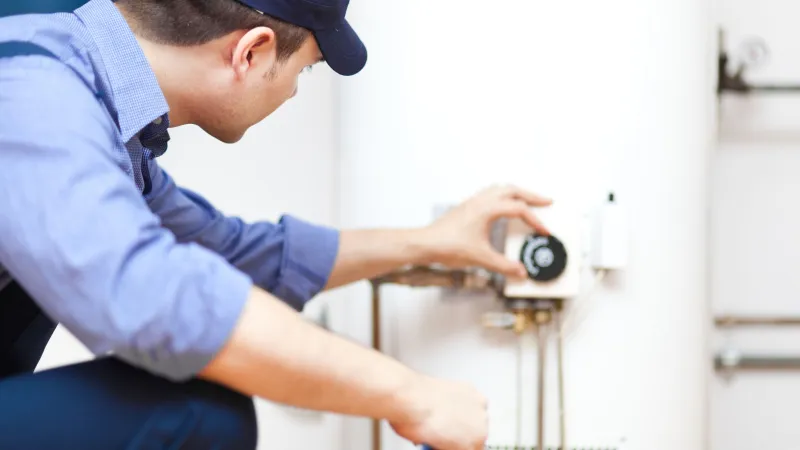 a man working on a water heater