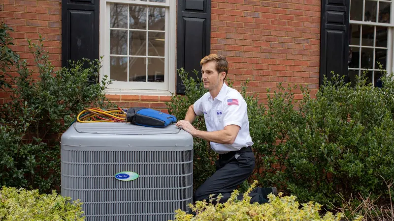 Air condition technician testing their completed repair at a home.