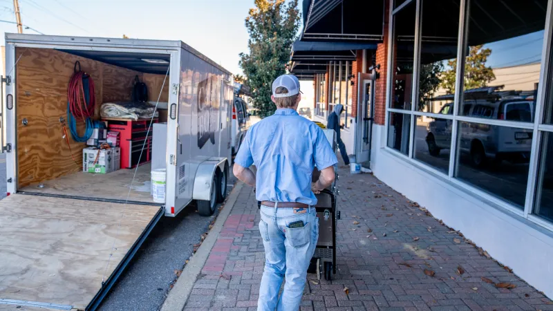 a man walking down a sidewalk