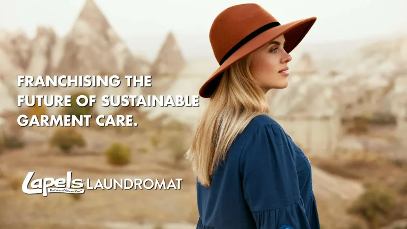 Woman in orange hat and blue dress stands outdoors with sustainable garment care franchising text