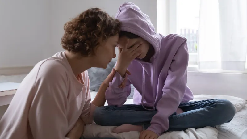a person kissing a baby