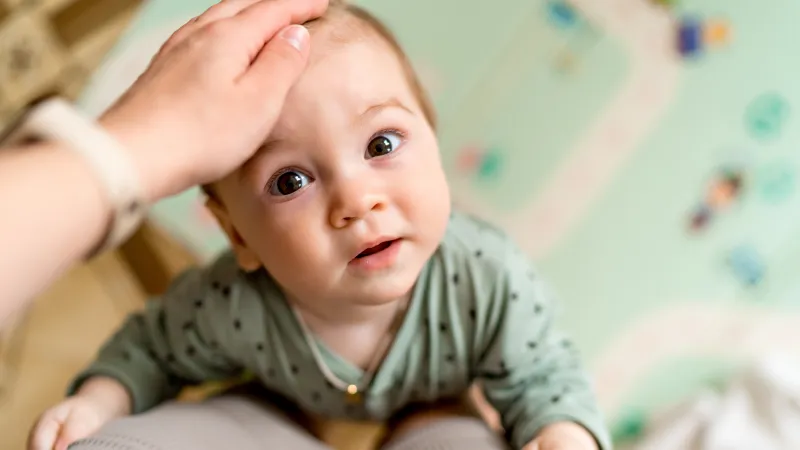 a baby being held by a person