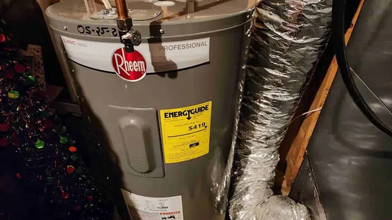 Rheem professional water heater installed in basement with copper pipes and insulated duct work nearby.