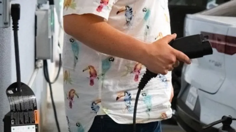 evel 1 charging cord plugged into standard 120 V wall outlet