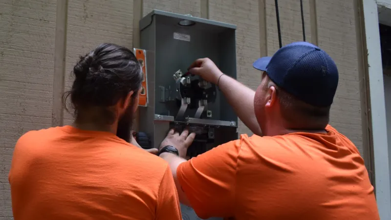 William and Josh installing a new panel in Brookhaven, Georgia