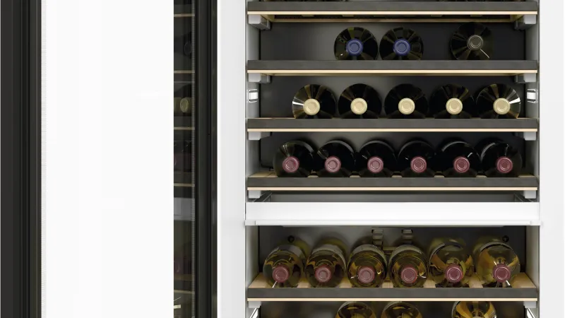 a white refrigerator with many bottles of wine in it