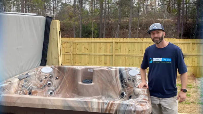 a man standing next to a large metal container