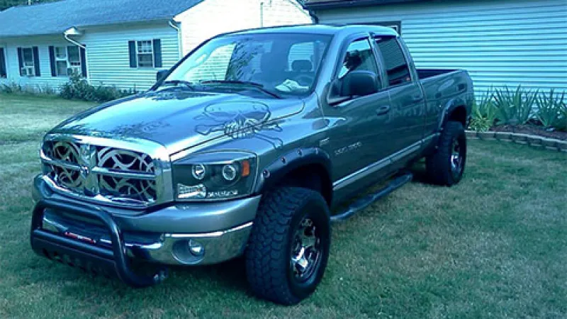 a black truck parked in a yard