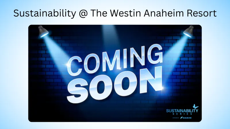 Coming Soon text illuminated by two spotlights on a blue brick wall for sustainability at The Westin Anaheim Resort.