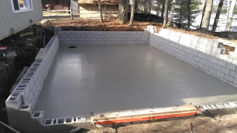 a swimming pool with a white wall