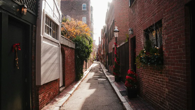 a narrow street between brick buildings