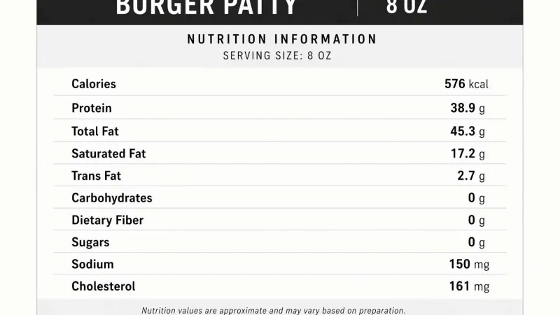 Cocktail glass with an orange peel and cherry next to a small creamy drink on a wooden bar surface.