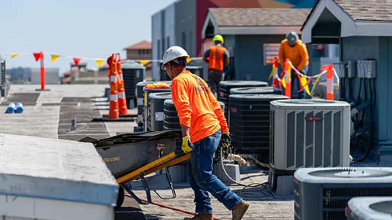 Mattco Roofing crew working on commercial flat roof College Station TX