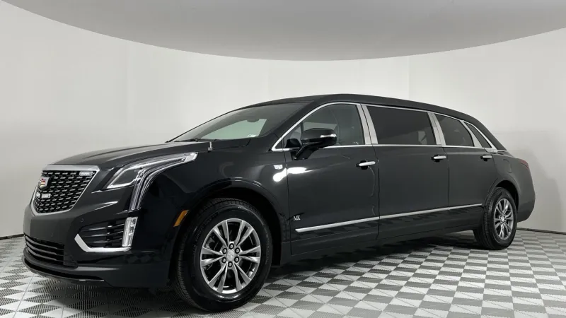 A sleek black Cadillac XT5 SUV showcased in a modern showroom setting.