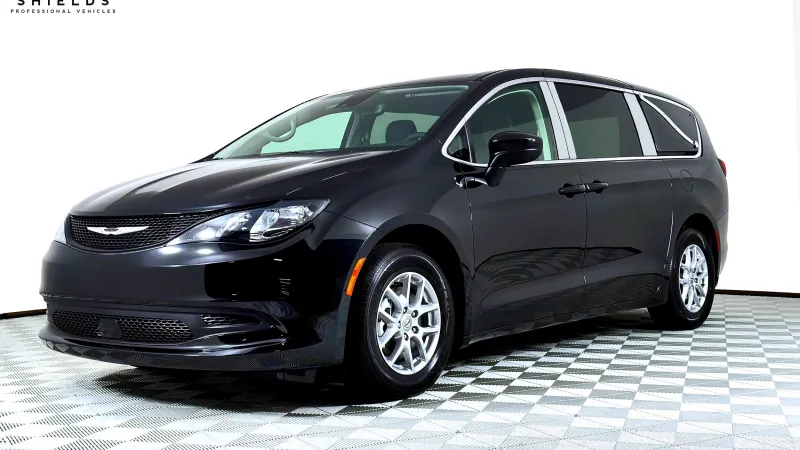A sleek black Chrysler minivan showcased in a well-lit display setting.