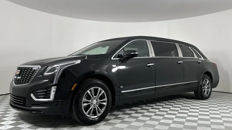 A sleek black Cadillac XT5 SUV showcased in a modern showroom setting.