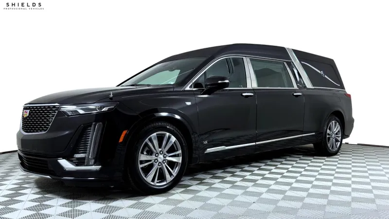 A sleek black Cadillac hearse parked on a checkered floor, showcasing its elegant design and luxury features.