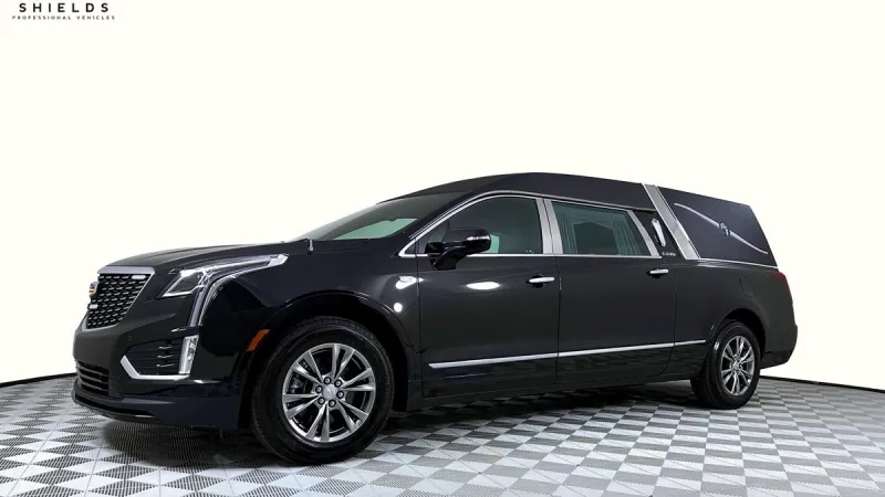Sleek black Cadillac hearse with polished exterior, showcasing luxury and professional design.