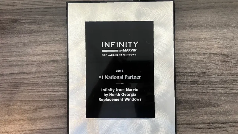 2018 Infinity from Marvin Replacement Windows #1 National Partner award plaque on wooden surface