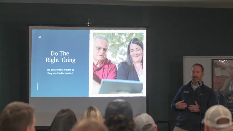 Speaker presents a slide titled Do The Right Thing with audience in a room focused on ethical behavior.