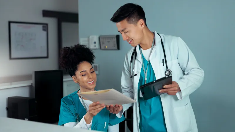a doctor showing a patient something on the tablet