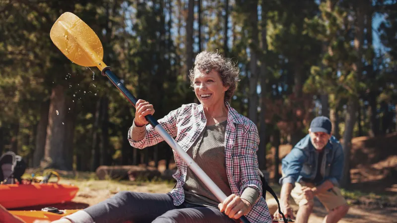 a person in a kayak holding a large paddle