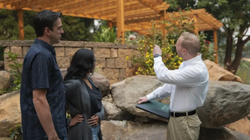 a group of people looking at a tablet